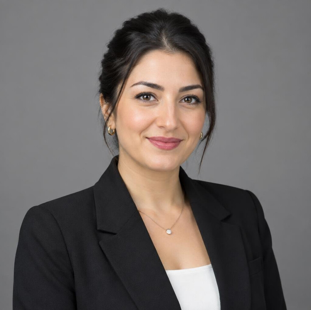 Turkish woman in her 30s with dark hair in business attire